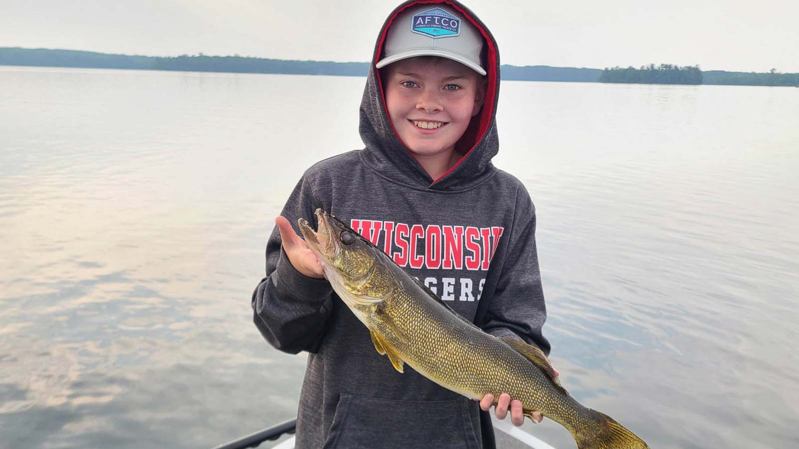 Boy holding a walleye he caught in Boulder Junction Wisconsin